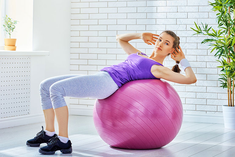 exercise-ball-crunches: best exercises to lose belly fat