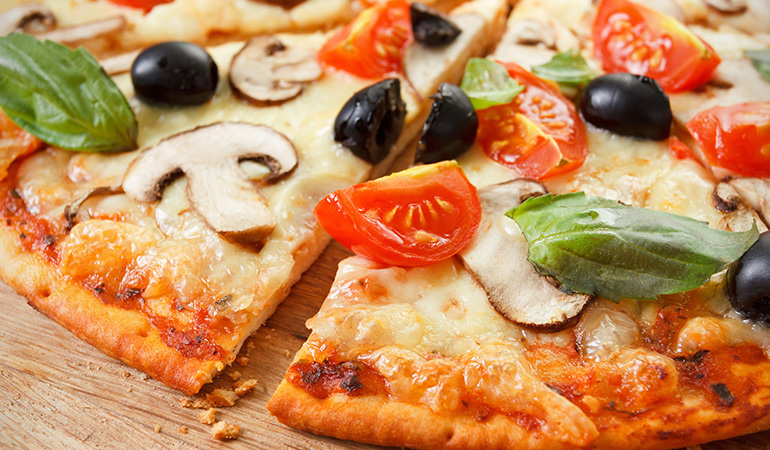 A slice of wild mushroom pizza makes a light and tasty dinner option
