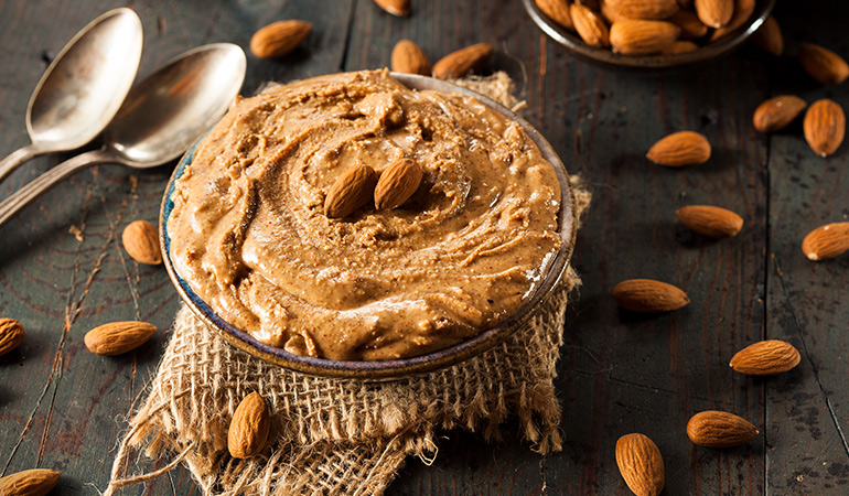 Two tablespoons of almond butter has 7.74 mg of vitamin E (51.6% DV) while 1 tablespoon of hazelnut oil has 6.42 mg of the vitamin (42.8% DV).